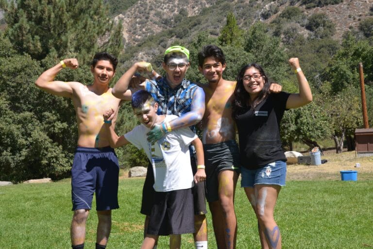 A group of high school students wearing body paint and posing