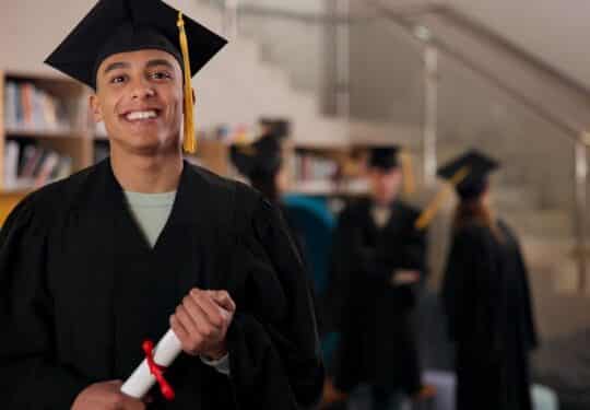 college graduate smiling holding degree