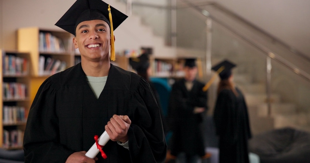 college graduate smiling holding degree